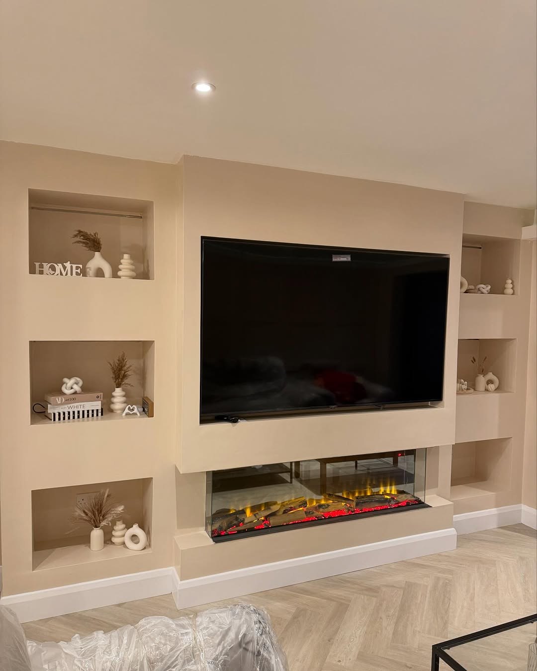 Living room media wall with shelves and fireplace
